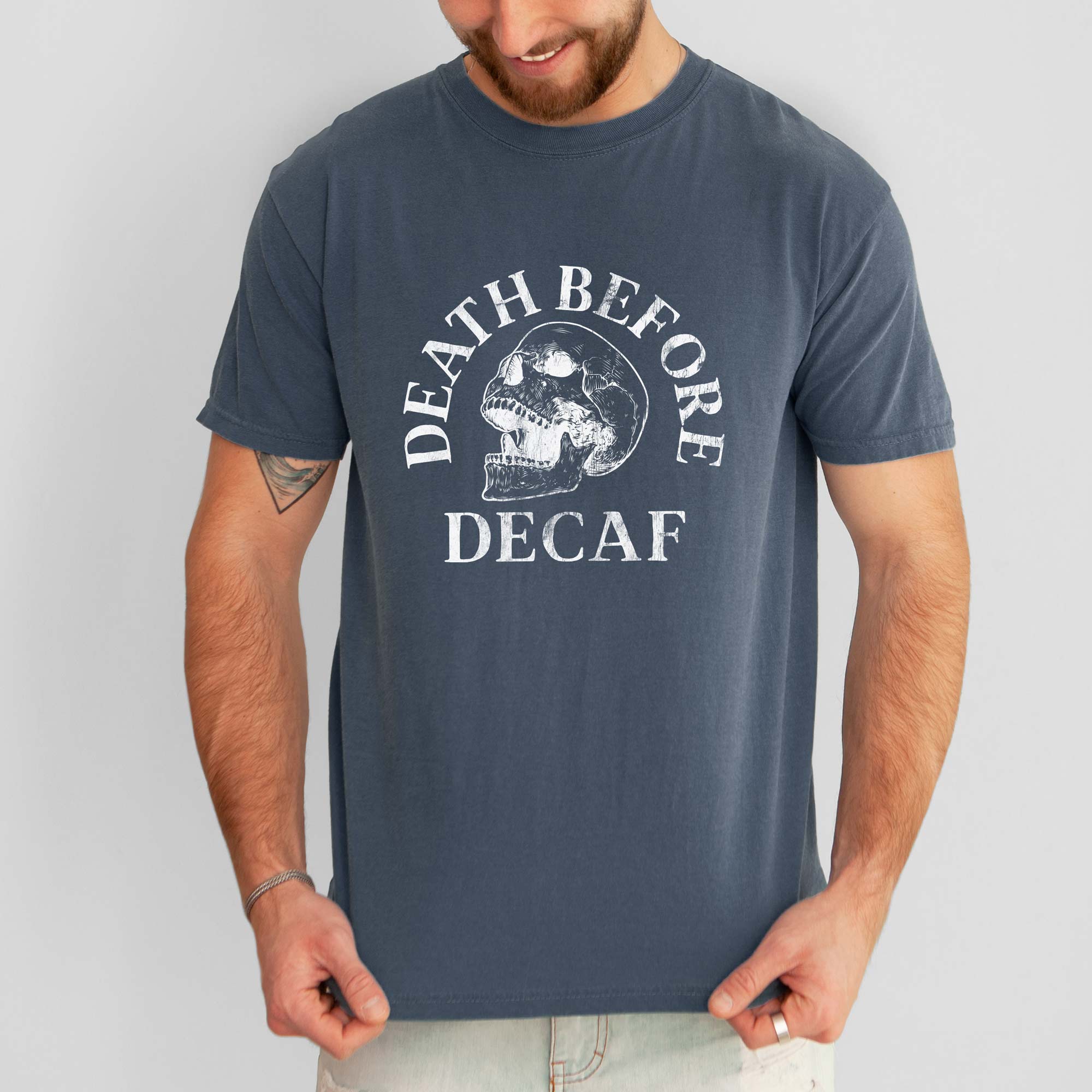 A man wearing a Death Before Decaf Garment Dyed Tee in denim