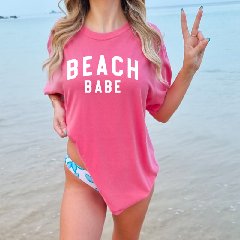 a woman wearing a Beach Babe Garment Dyed Tee in crunchberry