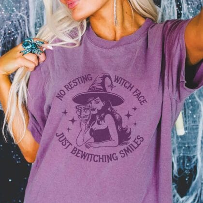 a woman wearing a bewitching smiles garment dyed tee in berry