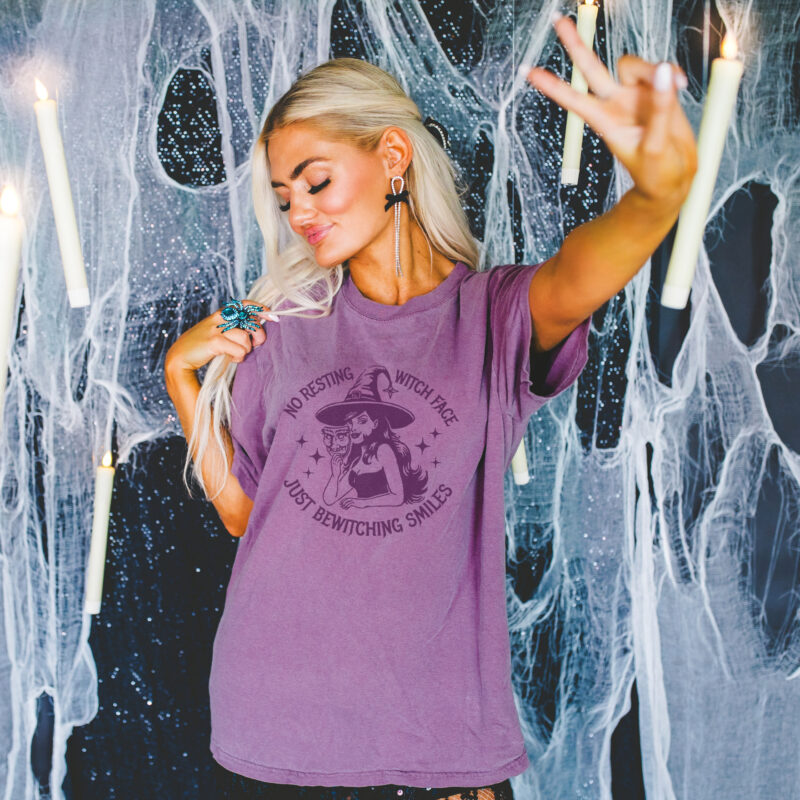a woman wearing a bewitching smiles garment dyed tee in berry