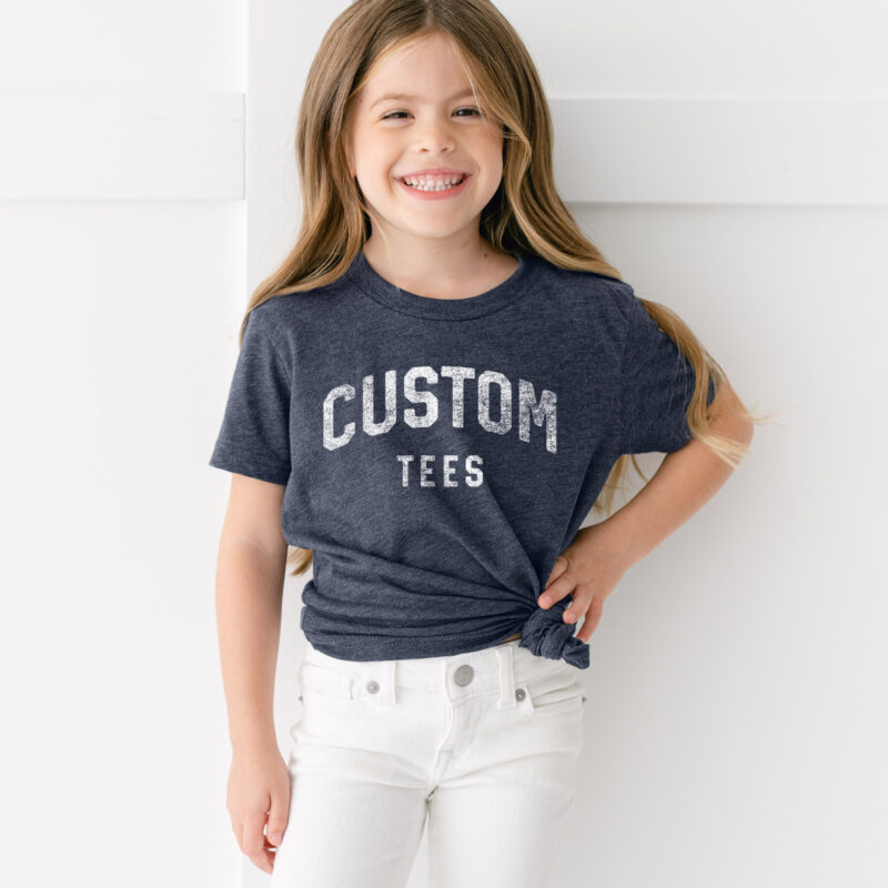 A little girl wearing a custom printed tee in heather navy