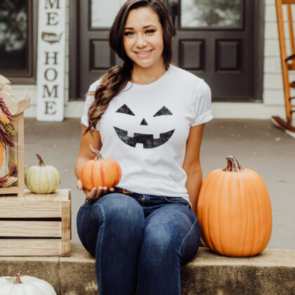 A woman wearing a Laughing Jack-o-lantern tee in white