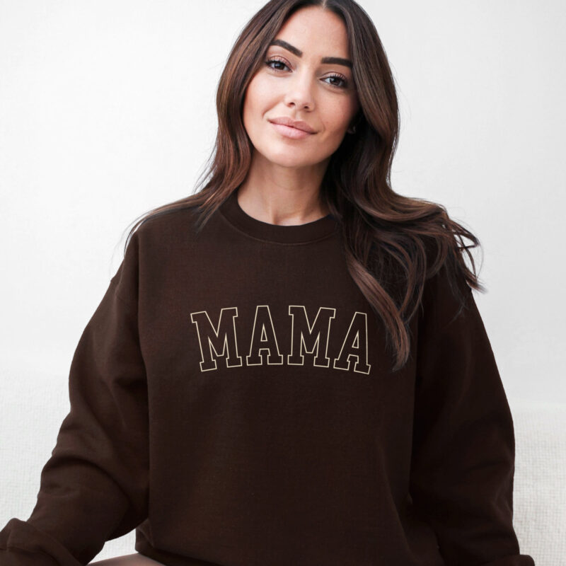 a woman wearing a monotone mama sweatshirt in dark chocolate