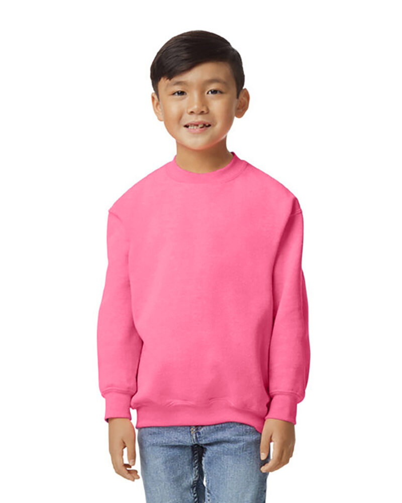 a boy wearing a custom youth crewneck sweatshirt in safety pink
