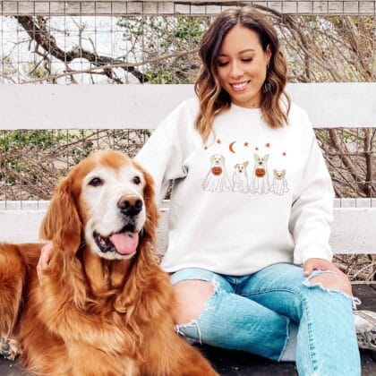 a woman wearing a ghost dogs sweatshirt in white