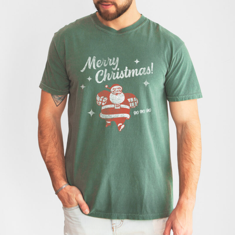a man wearing a retro santa Christmas tee in light green