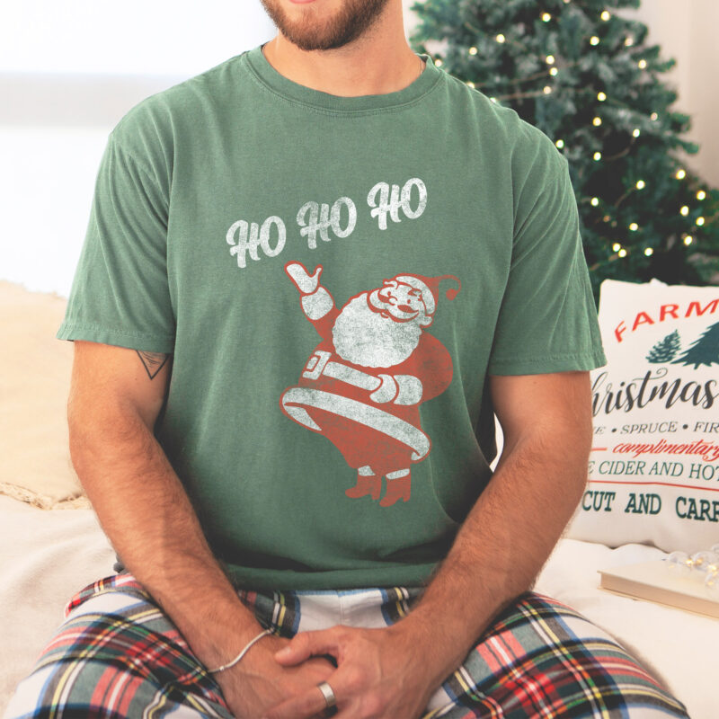 a man wearing a retro santa ho ho ho tee in light green