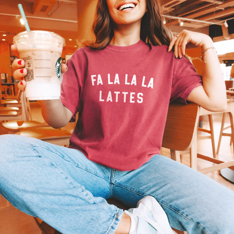 a woman wearing a fa la la la lattes t-shirt in crimson