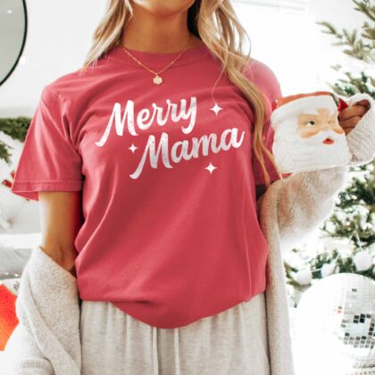 a woman wearing a retro merry mama tee in crimson