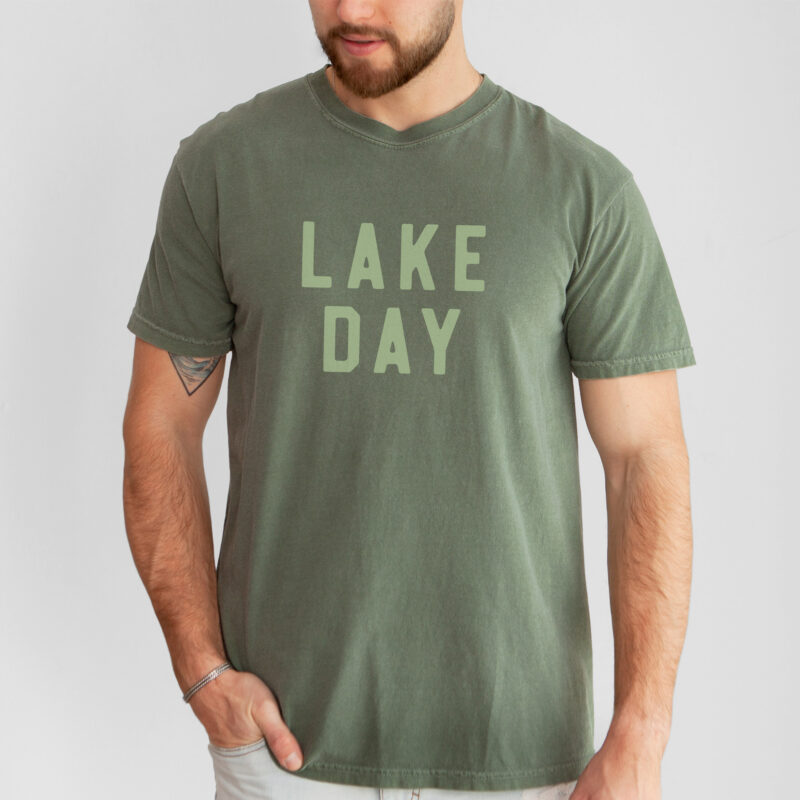 a man wearing a Lake Day T-Shirt in moss