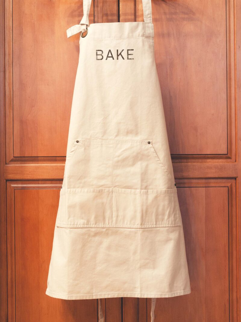 a cotton canvas BAKE apron in natural