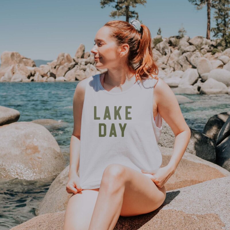 a woman wearing a lake day tank top in white