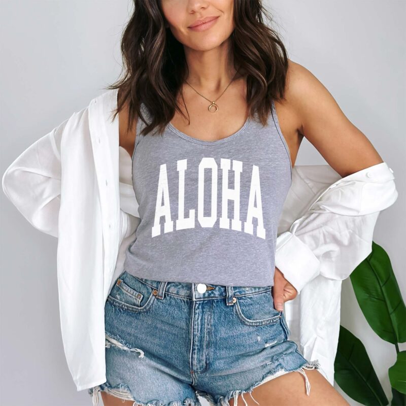 A woman wearing an aloha racerback tank in heather grey