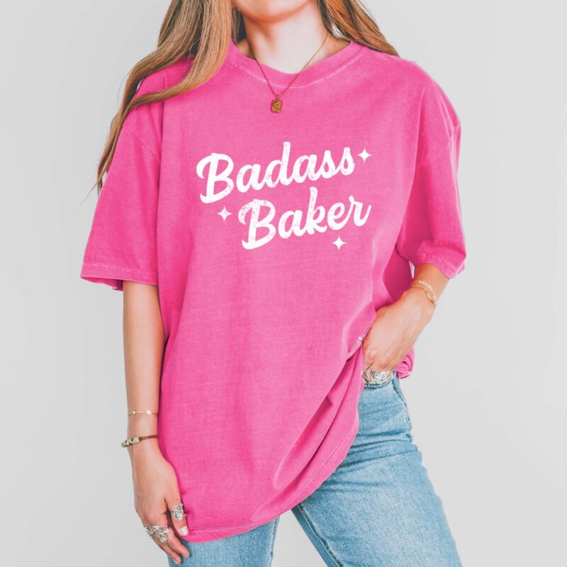 a woman wearing a Retro Badass Baker Garment Dyed Tee in crunchberry