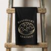 a sourdough therapy kitchen towel in black