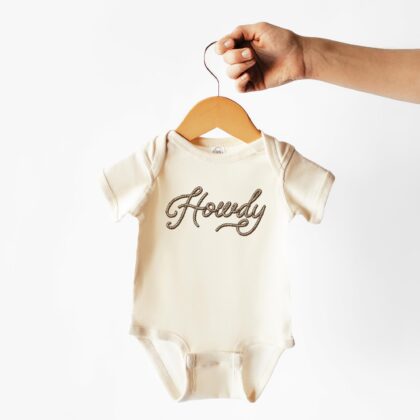 a Howdy Baby Rib Bodysuit in natural