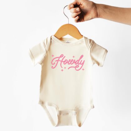 a Howdy Cowgirl Baby Rib Bodysuit in natural