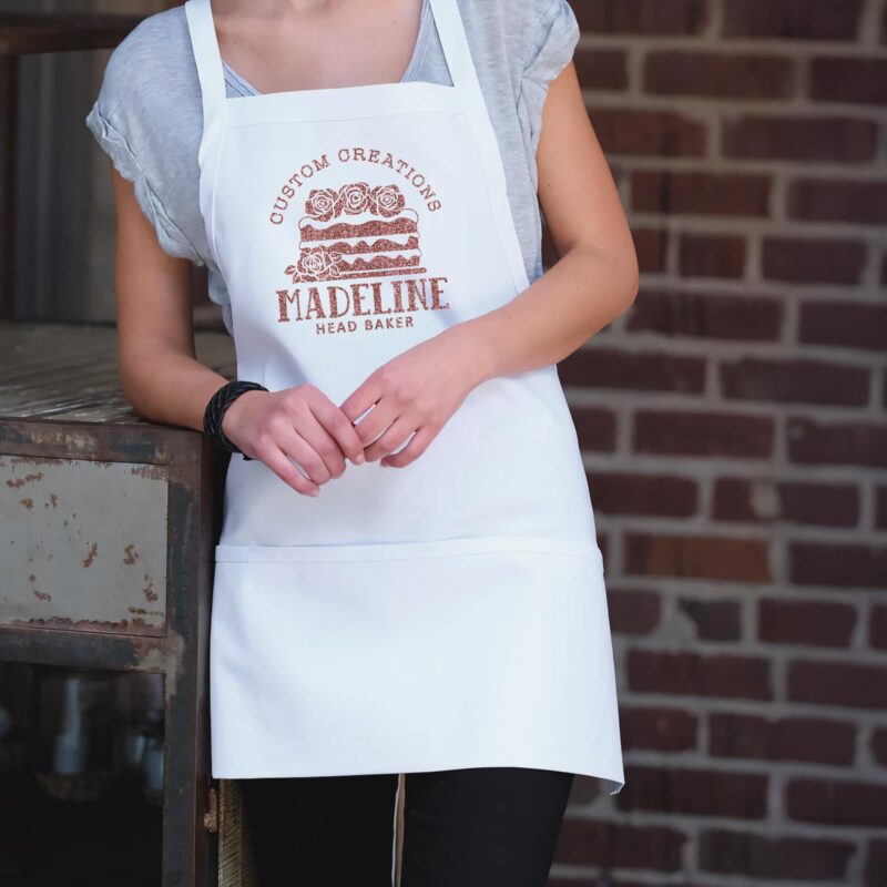 a woman wearing a Short Bib XL Personalized Cake Apron in white