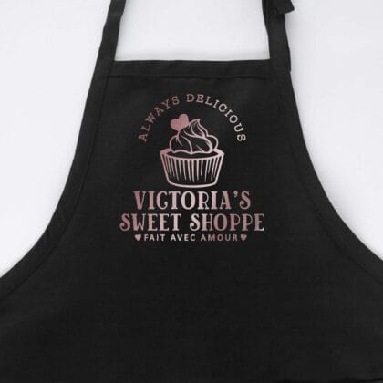 a cupcake baking apron in black