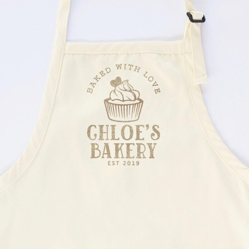 a cupcake baking apron in natural