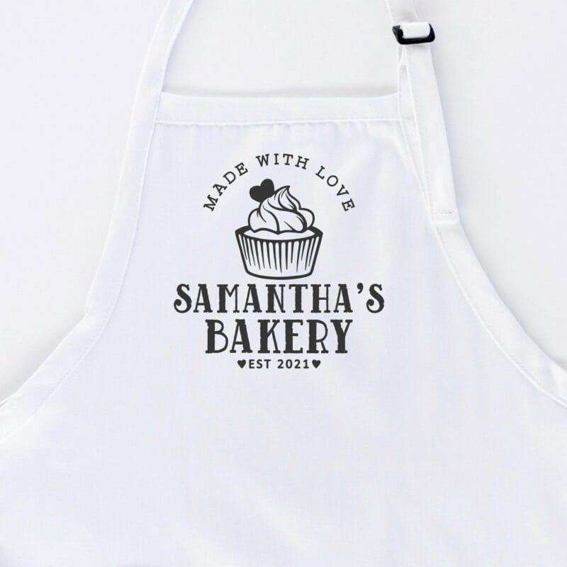 a cupcake baking apron in white