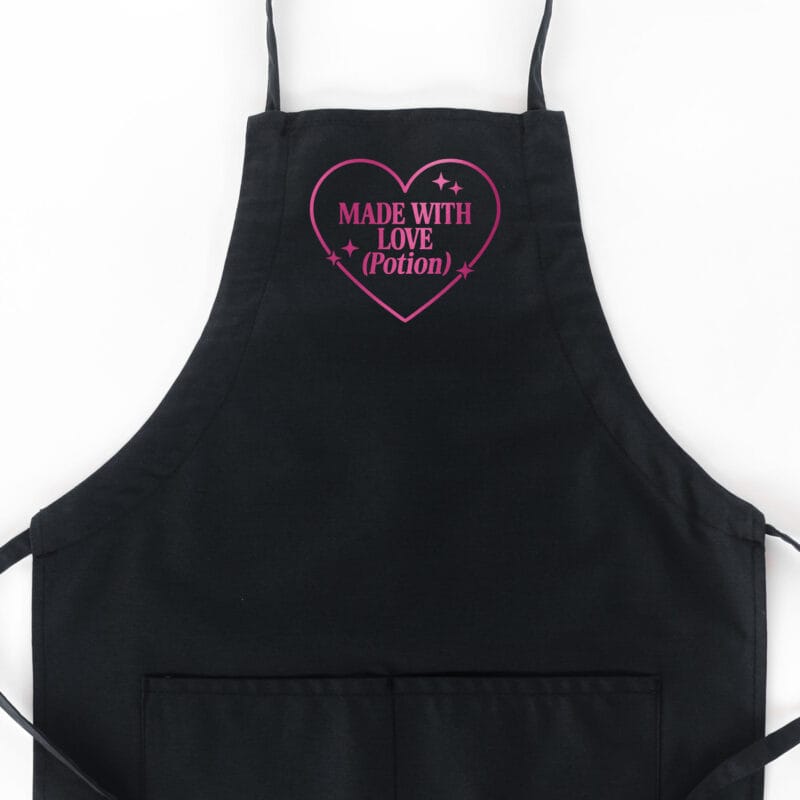 a Made With Love Potion Butcher Apron in black with a cherry metallic print