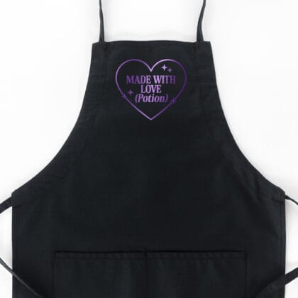 a Made With Love Potion Butcher Apron in black with a purple metallic print