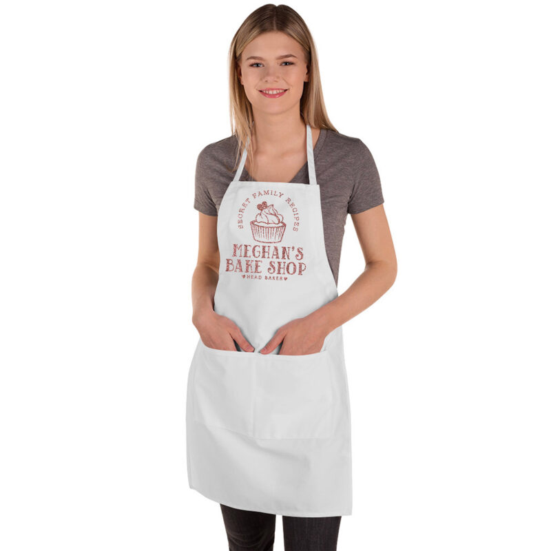 a young woman wearing a Personalized Butcher Cupcake Apron in white