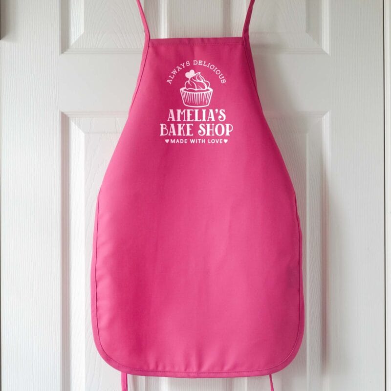 a premium personalized kids cupcake apron in hot pink