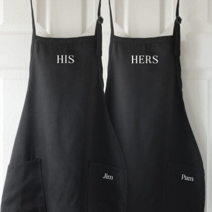 a personalized his hers apron set in black