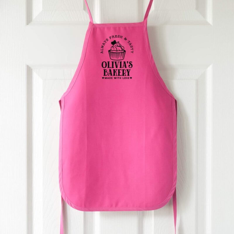 a personalized toddler cupcake baking apron in hot pink