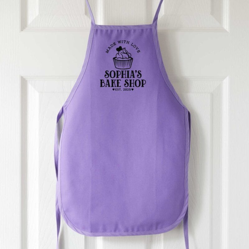 a personalized toddler cupcake baking apron in purple