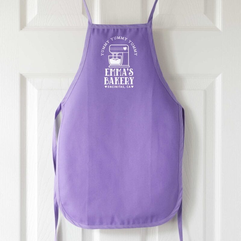 a personalized toddler mixer apron in purple