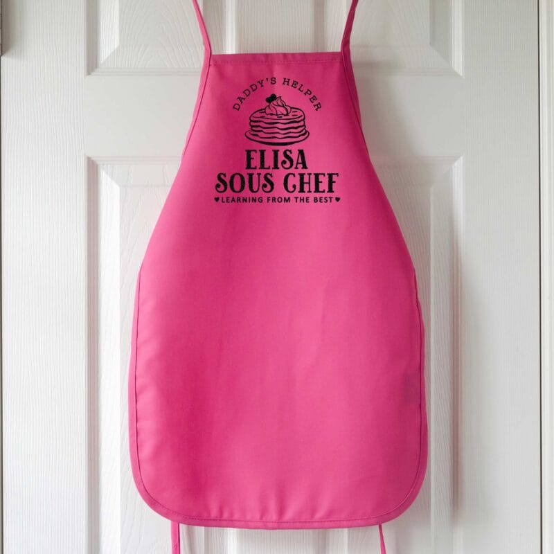 a kids personalized pancake apron in hot pink