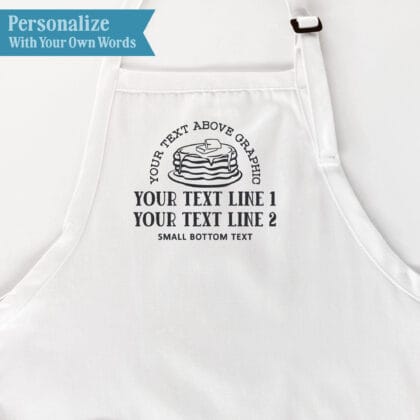 Pancake breakfast apron personalization guide showing text above the butter-and-syrup pancake graphic, two text lines below, and small bottom text.