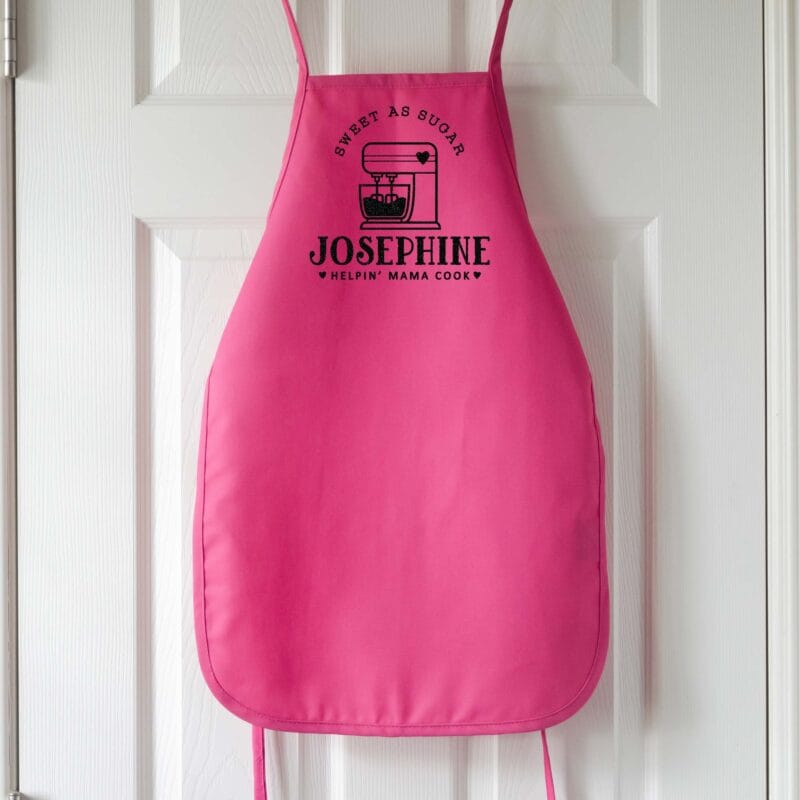 a kids personalized mixer apron in hot pink