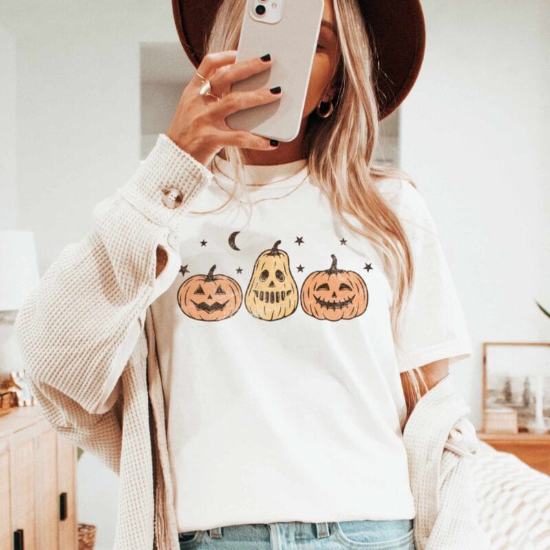 a woman wearing a Jack-O-Lanterns Halloween Tee in Ivory