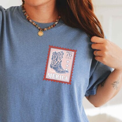 a young woman wearing a Merica Cowgirl Tee in blue jean