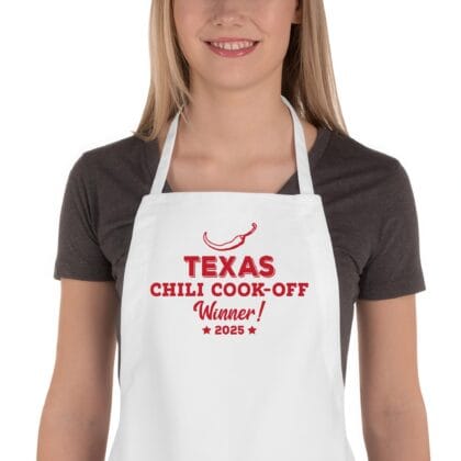 a woman wearing a Personalized Butcher Chili Cook-Off Winner Apron in white