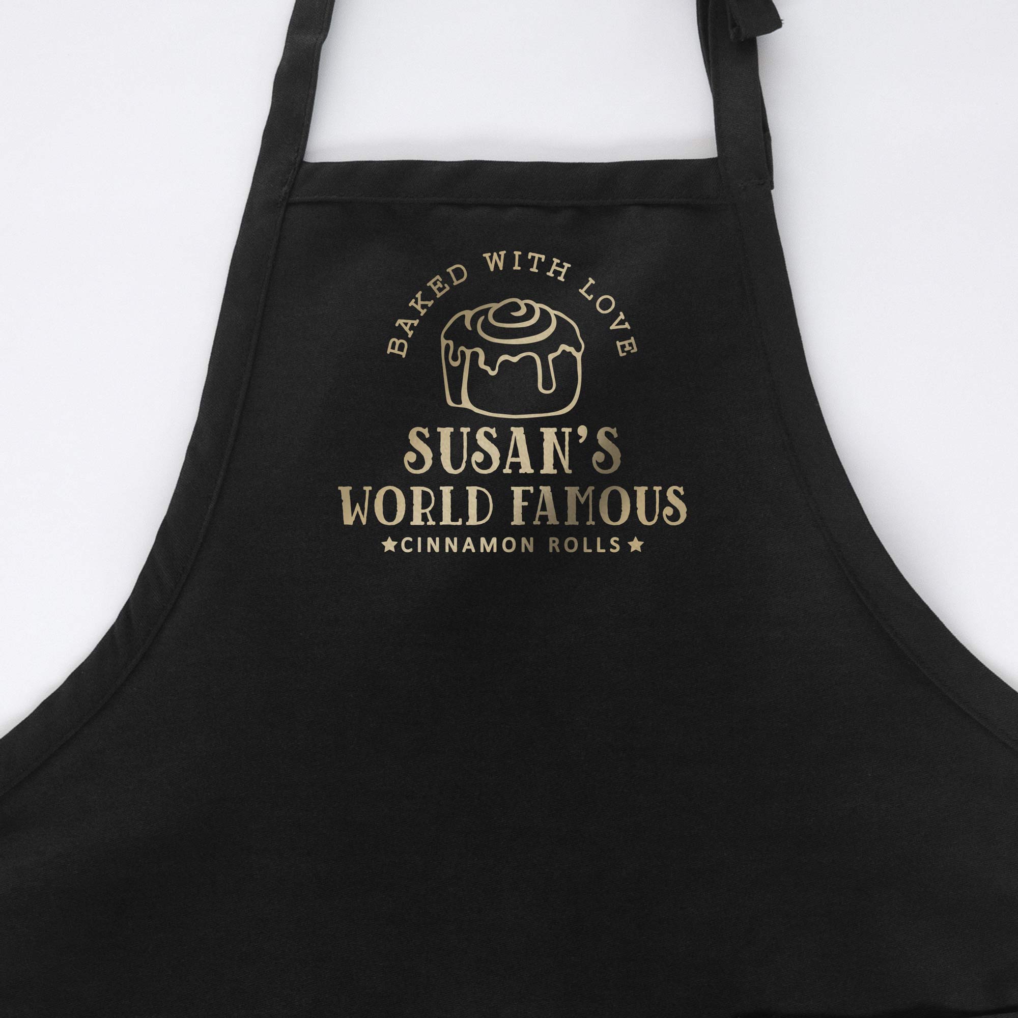a personalized cinnamon roll apron in black