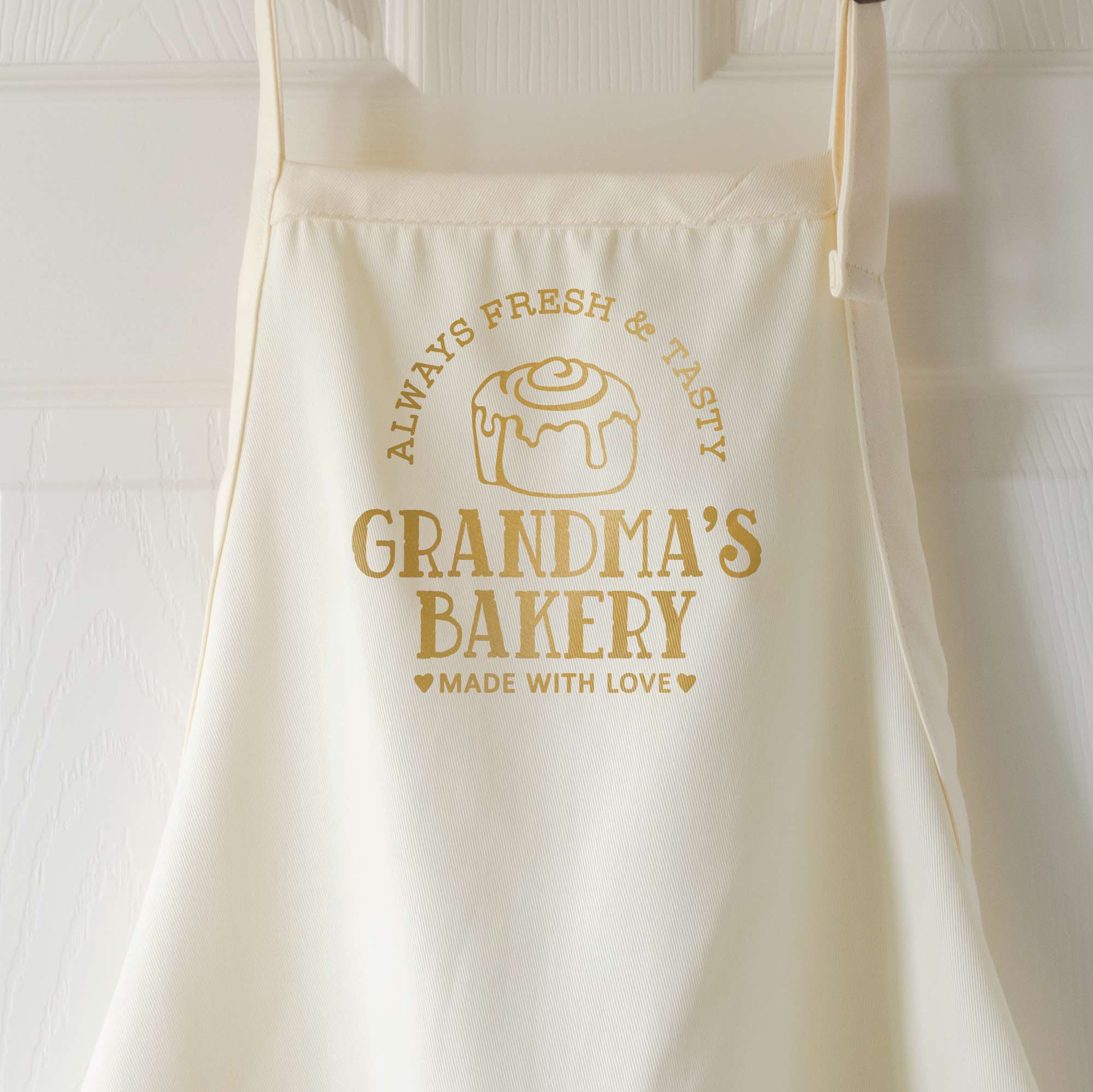 a personalized cinnamon roll apron in natural