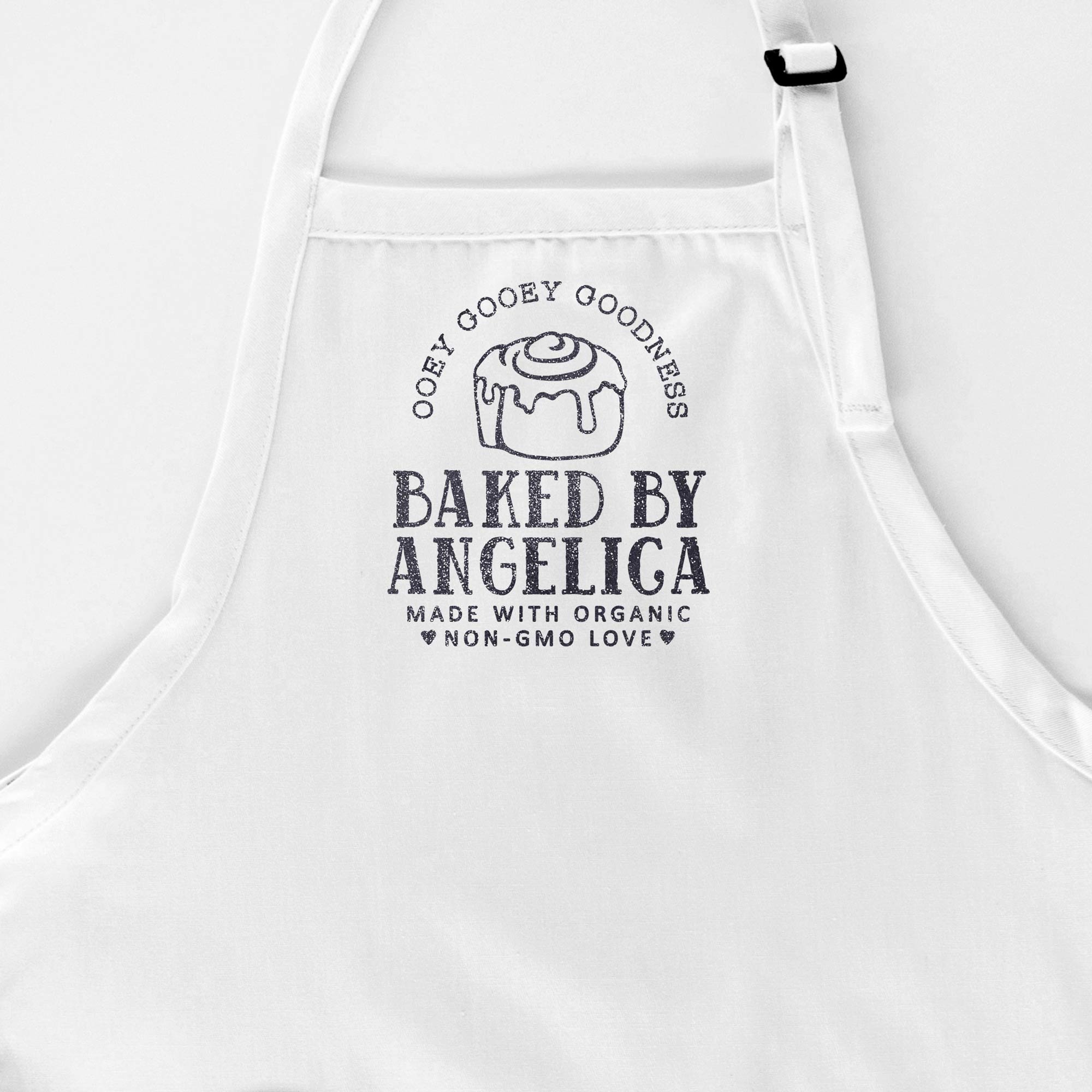 a personalized cinnamon roll apron in white