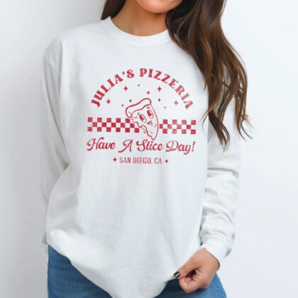 a woman wearing a long sleeve retro pizza t-shirt in white