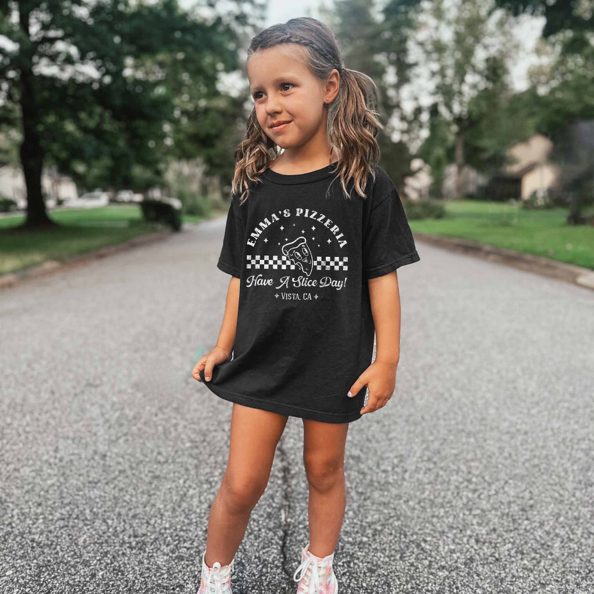 a little girl wearing a Personalized Kids Retro Pizza Shirt in black