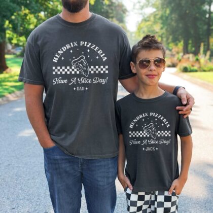 a man and a young boy wearing matching shirts, the boy is wearing a Personalized Kids Retro Pizza Shirt in pepper