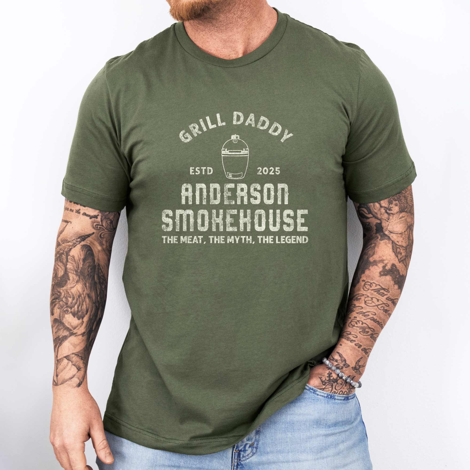 a man wearing a Personalized Meat Smoker T-Shirt in military green