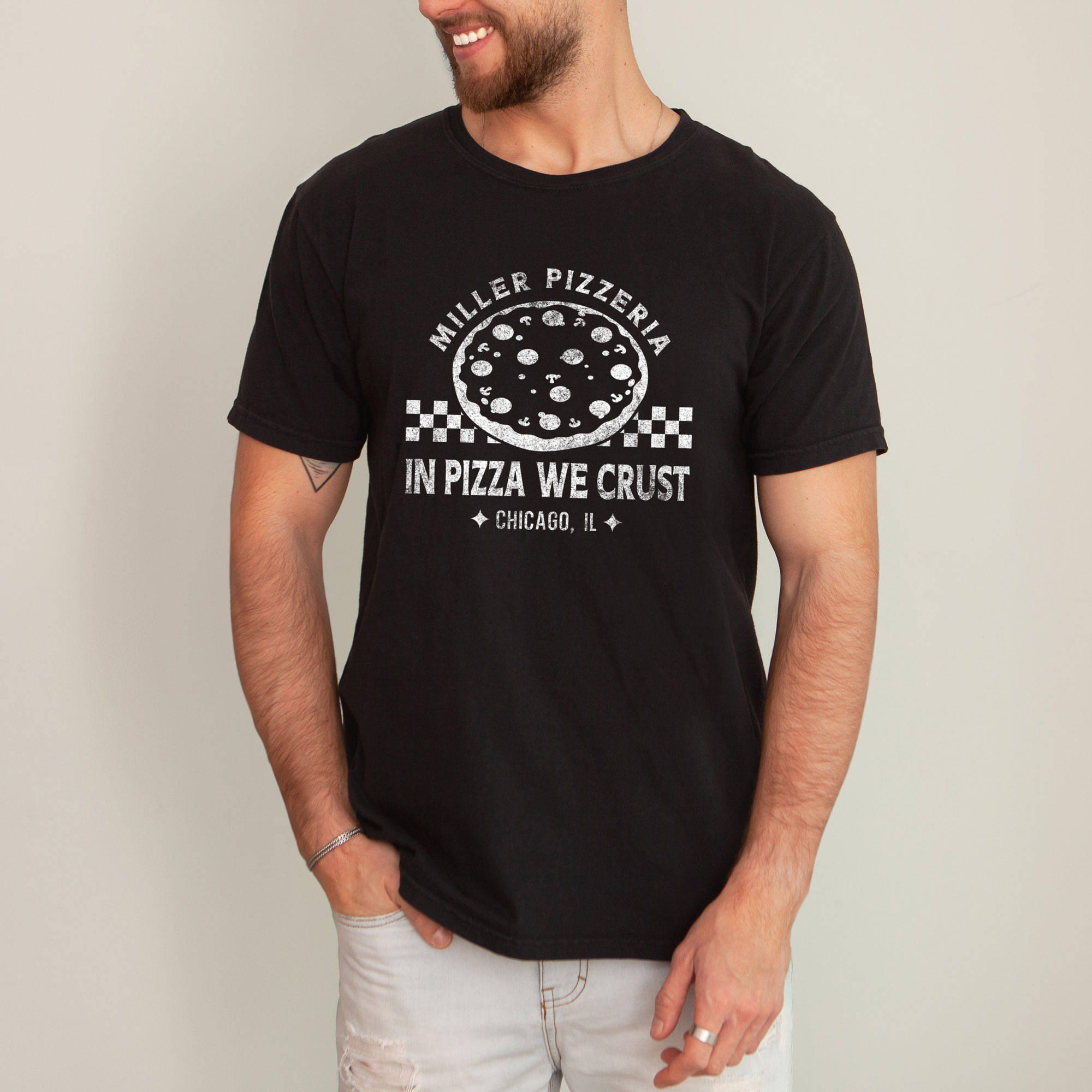 a man wearing a a checkered pizza t-shirt in black