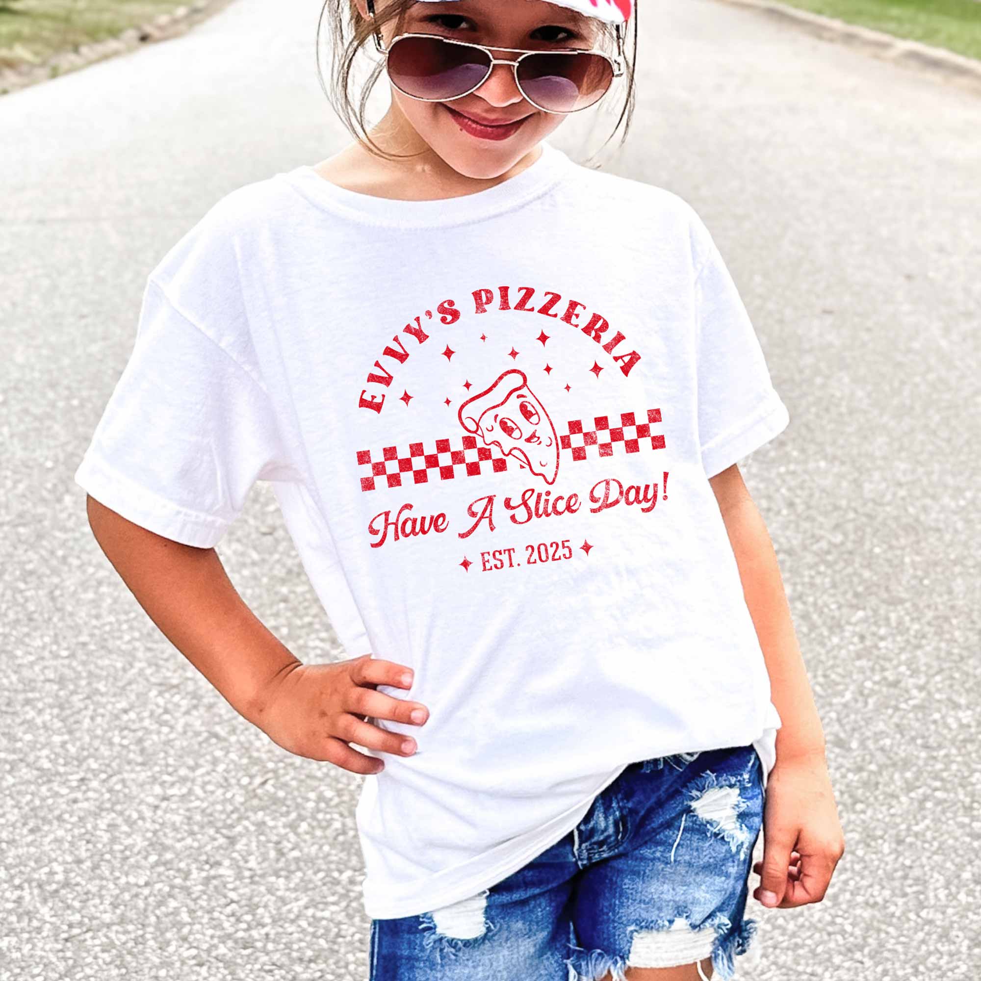 a little girl wearing a Personalized Kids Retro Pizza Shirt in white