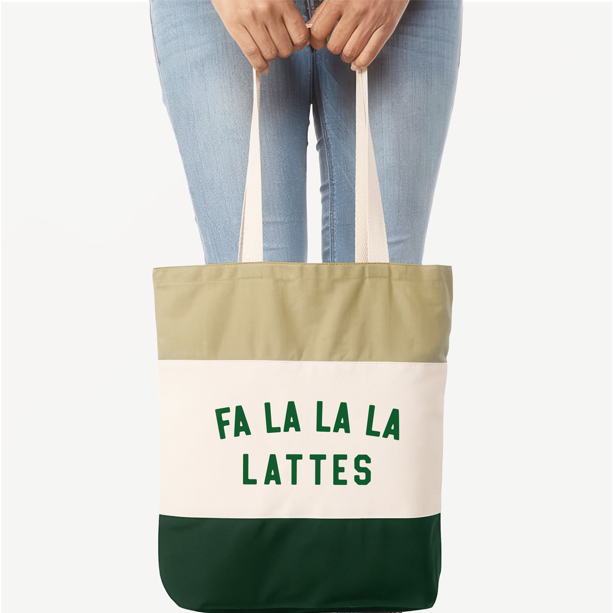 a woman holding a a Fa La La La Lattes Tote in forest green
