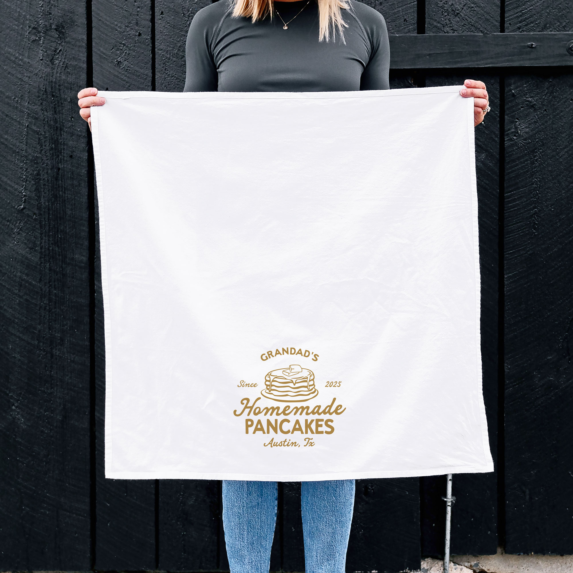 a woman holding a Pancake Chef Tea Towel in white